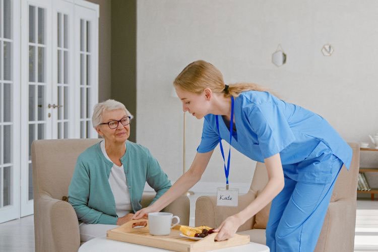 International patient recovering after surgery with nurse support in India