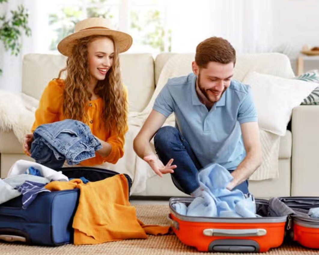 Patient packing a suitcase with medical documents and essentials before flying to India for treatment