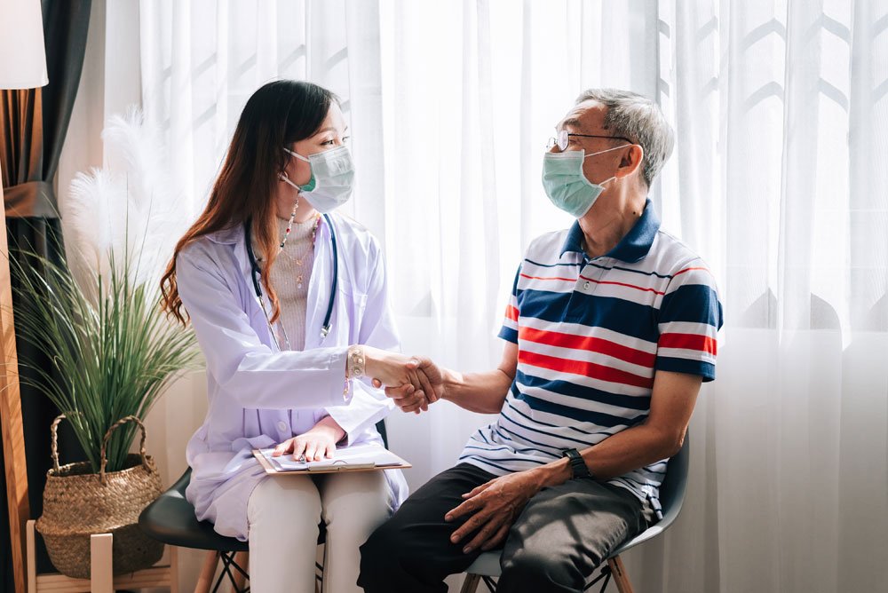 Bangladeshi patient and companion meeting a doctor at an Indian hospital to plan treatment
