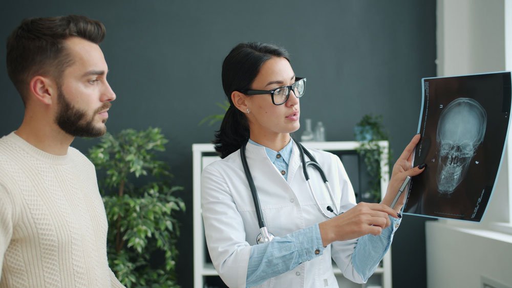 Omani patient and companion meeting a doctor at an Indian hospital to plan treatment