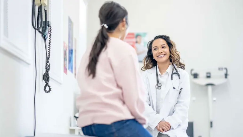 Patient from the UK and a companion meeting a doctor at an Indian hospital to plan treatment